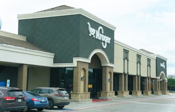 Irving, Texas, U.S - May 27, 2026 - Kroger grocery store exterior featuring brick columns, arched entrances, modern facade, and multiple parked cars.