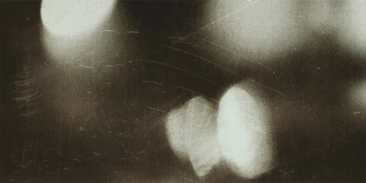 Abstract blurred light bokeh circles on dark background with soft ethereal white light bokeh spheres floating against a dark textured surface abstract background defocused minimalist
