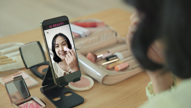 Asia people young gen z female happy smile enjoy phone apply selfie screen makeup blush virtual AI tech scan face app AR mixed augmented reality future beauty smart iot skin care help guide advice.