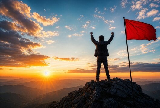 Victorious man on mountain peak raises arms in triumph beside a red flag at sunrise, symbolizing success, leadership, and overcoming challenges