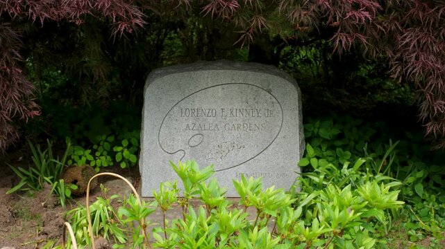 Stone marker for Lorenzo F Kinney Jr Azalea Gardens, university botanical park entrance plaque