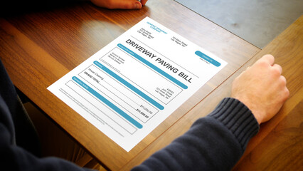 Fototapeta premium A Stressed Out Homeowner Looks at Generic Driveway Pavement Bill