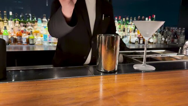 Japanese Bartender Adding Bitters to a Cocktail Shaker in Kanazawa Bar