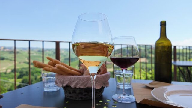 Slow Motion White Wine Swirl on Terrace Overlooking Italian Vineyards