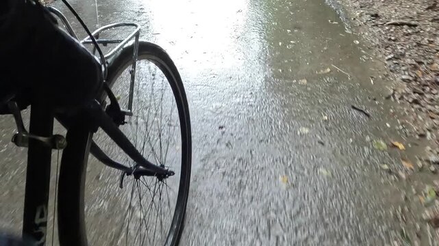 wet rain cycling bicycle riding in small village coastal town adriatic mediterranean sea slovenia piran puddle pedestrian seaside path travel storm rainy tunnel trail nature adventure tourism travel