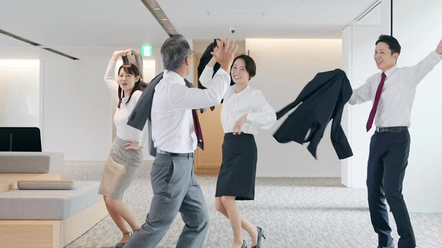 オフィスでダンスするビジネスパーソンのグループ