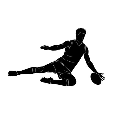 Silhouette of a football player in action, kicking the ball while lying on the ground