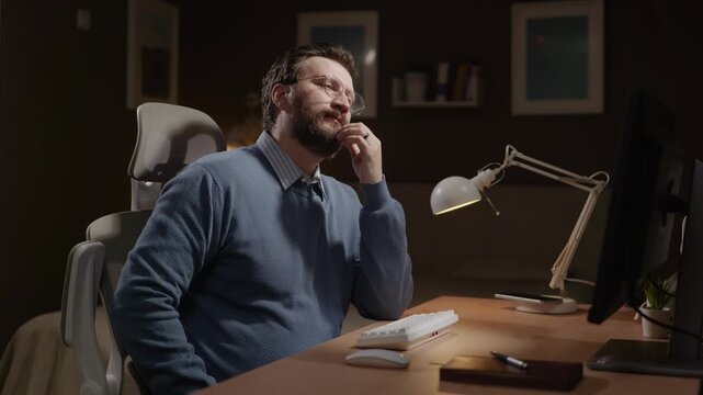 Pensive freelancer, man thinking. Focused male freelancer stares thoughtfully at computer screen