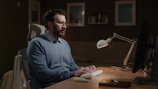 Male freelancer saw something scary on computer screen, fear and anxiety visible on his face. Trouble, shock, fear and financial loss concept