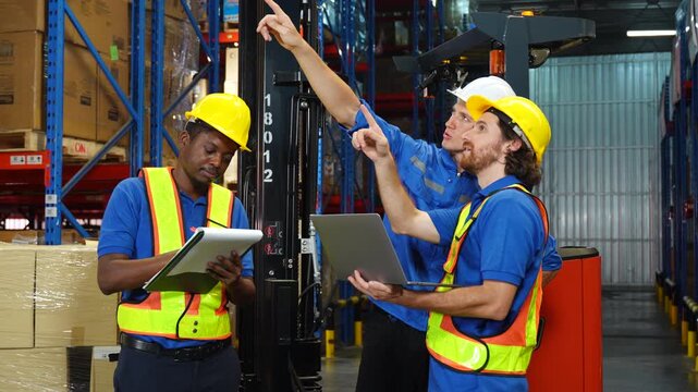 Worker discuss in warehouse using laptop in conversation. Safety inspection,Training employee for logistic employee in warehouse. Digital technology, Team meeting and supply chain with manager for hel