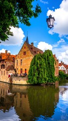 Naklejka premium A serene scene of a historic town with a canal and lush greenery
