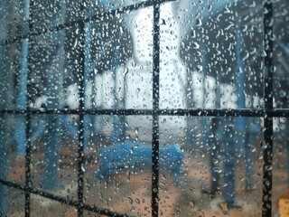 Obraz premium Abstract Rain Texture on Glass with Blue Industrial Background