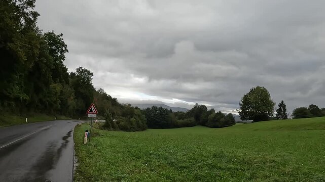 wet rain cycling bicycle riding in small village coastal town adriatic mediterranean sea slovenia piran puddle pedestrian seaside path travel storm rainy tunnel trail nature adventure tourism travel