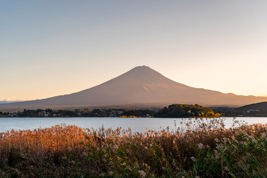 Beautiful view of Mount Fuji with glowing golden light at sunset at Kawaguchiko Lake