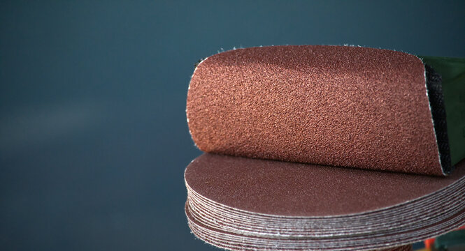Stack of round sandpaper discs for orbital sander, close-up detail
