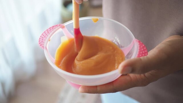 Preparing baby food in a bright kitchen during daytime