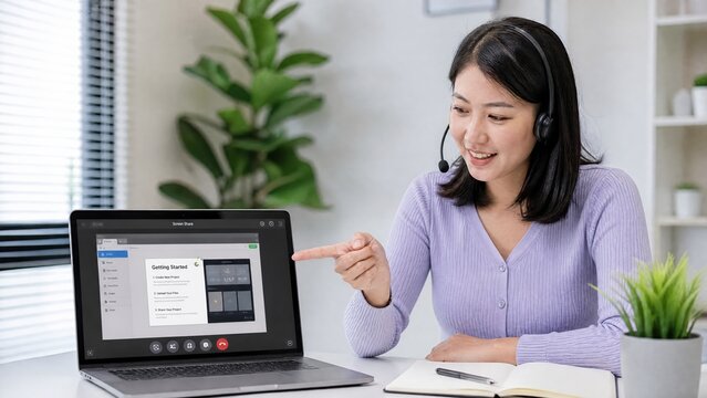 Generative AI, Smiling Asian Woman with Headset Pointing at Laptop Screen