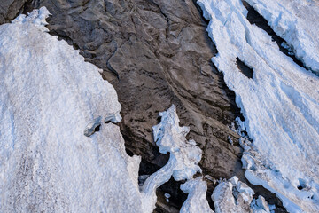 Fototapeta premium Aerial View Of Glacier Snow And Exposed Rock Crevasse On Alpine Slope In BC, Canada