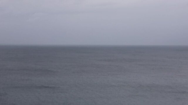 out of focus view of the Mediterranean sea during a storm cloudy grey day texture blurry ocean waves dreary moody wet cold unpleasant weather outside view