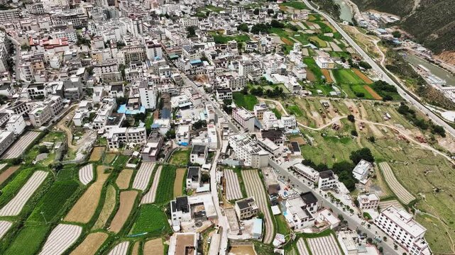 Aerial view of town, farmland and river valley in a mountainous rural landscape