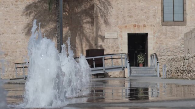 Entrance to the Altamira Palace with the fountains blurred in super slow motion. Elche, Spain.