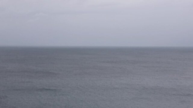 out of focus view of the Mediterranean sea during a storm cloudy grey day texture blurry ocean waves dreary moody wet cold unpleasant weather outside view