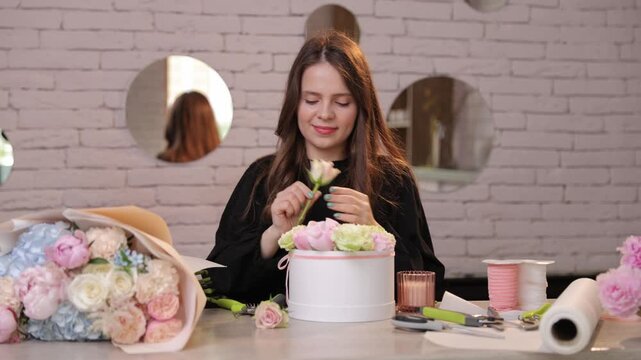 Florist designing luxury flower box arrangement for special occasion gift