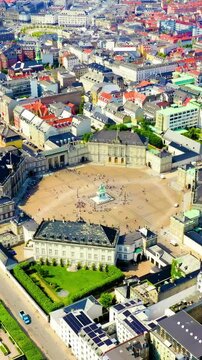 Vertical video. Copenhagen, Denmark. Amalienborg. The palace complex of the XVIII century in the Rococo style. Drone footage, Point of interest. Rich colors