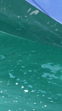 Close Up of Bilge Pump Water Discharging From Boat Hull