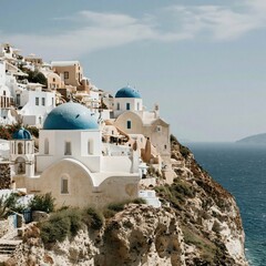 Fototapeta premium Whitewashed coastal architecture with blue domed churches built on a volcanic cliff for luxury travel brochures, Mediterranean honeymoon branding and vacation advertising
