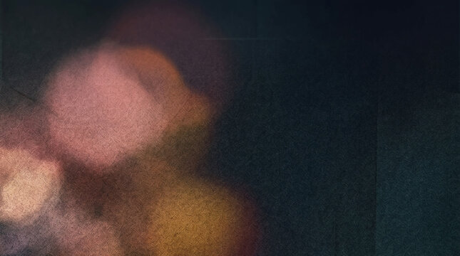 Grunge Blurred bokeh lights, dark textured background with orange and purple hues