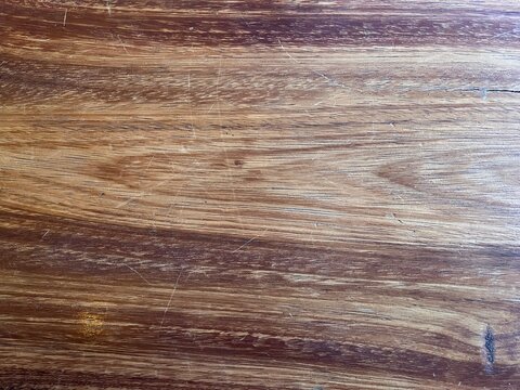Natural Parota Wood Table Texture with Bold Grain. Natural wood table with scratches. Background of parota wood table.