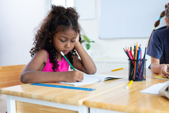 girl is studying and doing her homework in the classroom.