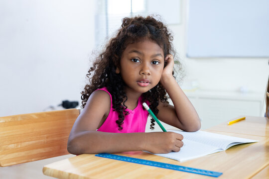 girl is studying and doing her homework in the classroom.