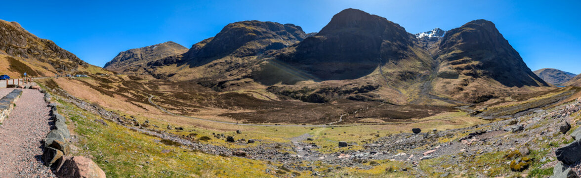 Panoramic view of the Glen Coe valley in the Scottish Highlands. The picturesque A82, surrounded by the Three Sisters mountains in Glen Coe in the Scottish Highlands
