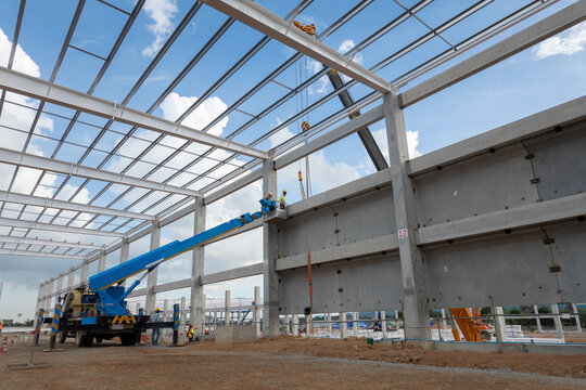 Industrial Construction Site: A large-scale industrial building under construction, featuring a steel frame structure and concrete walls.