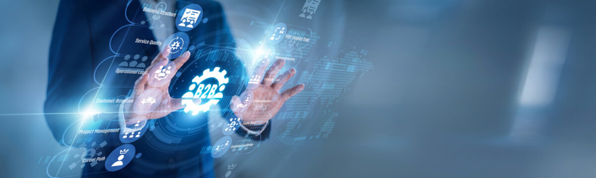 B2B manager touching virtual screen with partnership icons for B2B Business, managing clients, suppliers, contracts, orders, sales growth, and professional company relationships online.