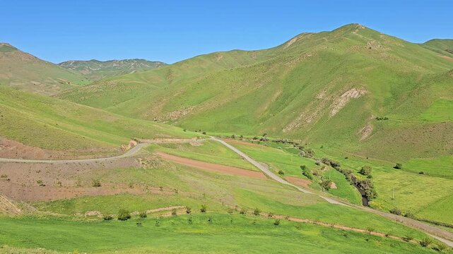 A winding path through rolling green hills under a bright blue spring sky, creating a peaceful and open rural landscape.
📍 Marivan, Kurdistan, Iran 