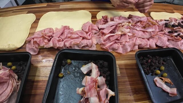 Chef Hands adding raisins into pan de jam&oacute;n preparation, traditional Venezuelan festive food