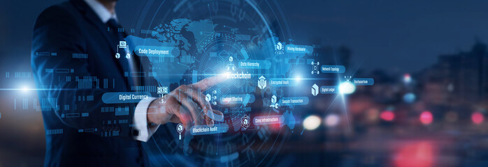 Obraz premium Developer hand touching Blockchain words and icons on a ledger screen. Securing decentralized transactions and managing encrypted digital records across a peer-to-peer network structure.