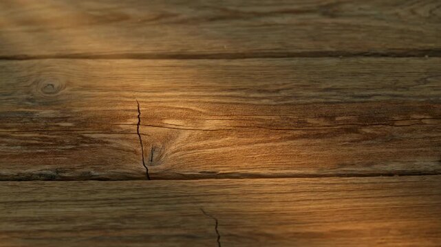 Rustic wooden plank texture close up with deep cracks and rich natural grain background