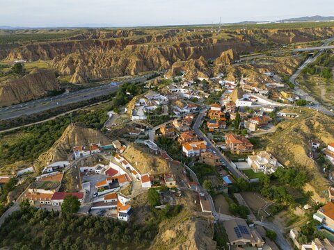 Aerial view of a village in a hilly landscape with traditional houses and rugged rocks, aerial view, cave hotel, Cuevas Pedro Antonio de Alarcon, Guadix, Granada, Andalusia, Spain