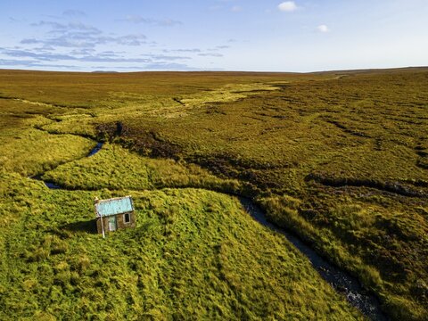 Aerial of a little hut in the Moorland on the Isle of Lewis, Outer Hebrides, Scotland, UK