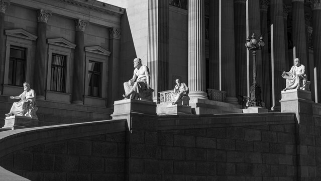 Stone figures on the driveway to the parliament building, black and white photograph, Vienna, Austria