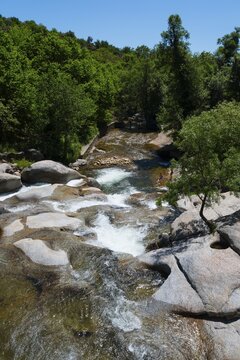 A picturesque river flowing over rocks, surrounded by green trees on a sunny day, Piscina natural, natural pool, Garganta la Olla, Sierra de Tormantos, C&aacute;ceres, Caceres, Extremadura, Spain