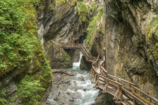 Wooden footbridge on a rock face over the mountain river Kapruner Ache in gorge, Sigmund-Thun-Klamm, Kaprun, Salzburg, Austria