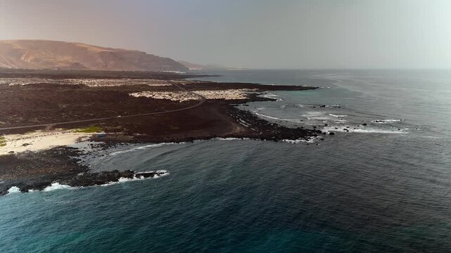 Aerial drone pan of Caleton Blanco coastline and La Graciosa island, Lanzarote