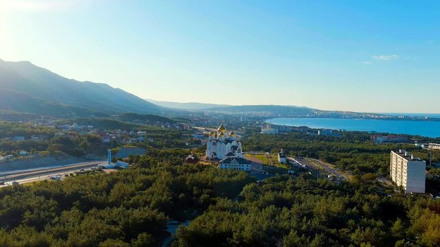 Gelendzhik, Russia. Cathedral of St. Andrew the First-Called. The text at the entrance to the city is translated as Gelenzhik-City Resort. Drone footage