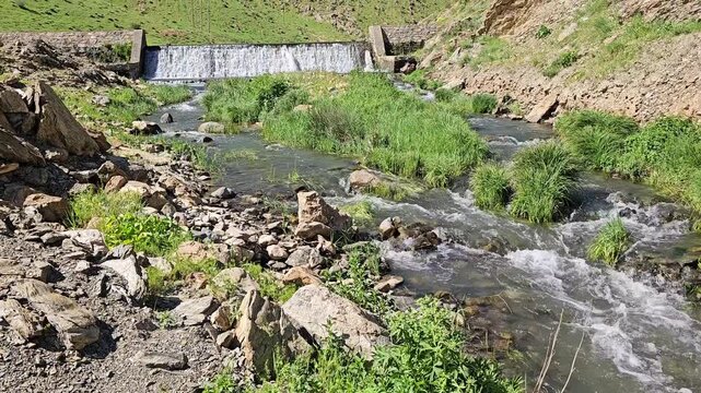 Small spring dam with flowing water between green hills, creating a peaceful natural scene with rocks, vegetation, and clear blue sky.
📍 Marivan, Kurdisatn, Iran 
