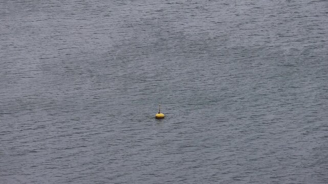 small buoy floating in the adriatic sea mediterranean coast of slovenia in piran guiding ships avoiding danger float floaty navigation safety warning shallow water boat travel ocean current bobbing up